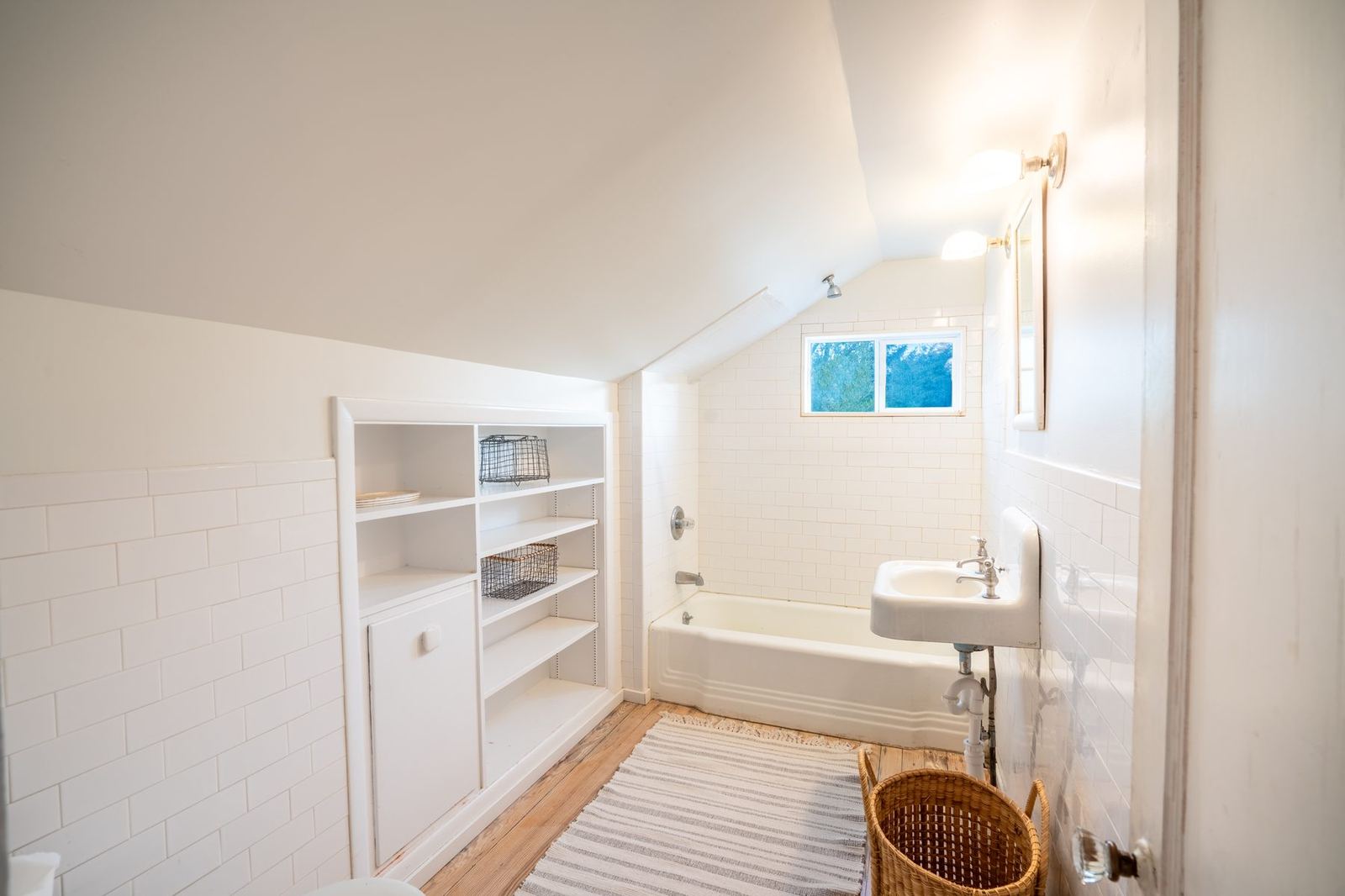 Half-bath under pitched ceiling with subway tile