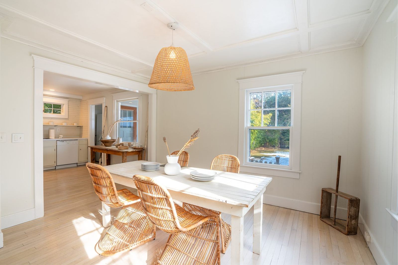 Dining room with rattan chairs and a pendant lantern